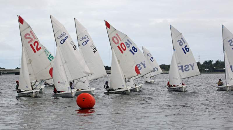 sailboats approaching a buoy